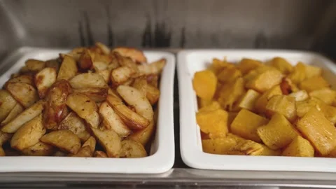 Roasted potato wedges and squash in serving trays Stock Footage 341166266