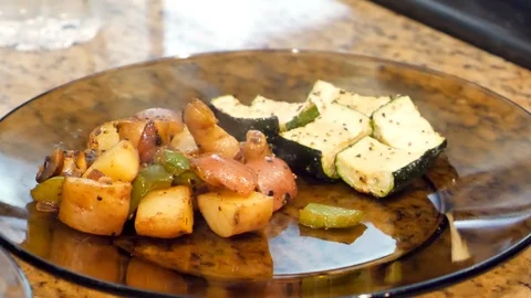 Roasted potatoes and mixed vegetables served on glass plate Stock Footage 127173375