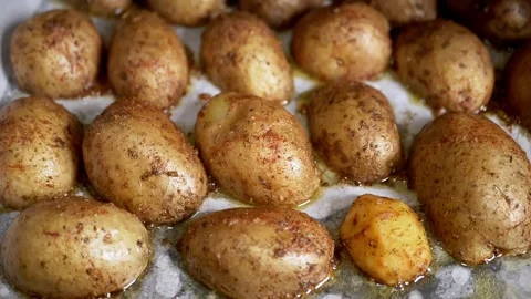 Roasted Potatoes on a Baking Sheet Lined with Parchment Paper Stock Footage 339067840