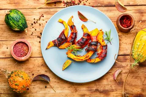 Roasted pumpkin with bacon. Stock Photos