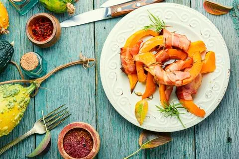 Roasted pumpkin with bacon. Stock Photos