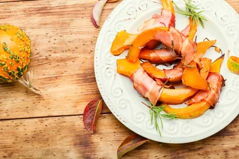 Roasted pumpkin with bacon. Stock Photos