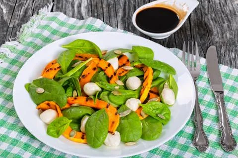 Roasted pumpkin, mini mozzarella and spinach autumn salad Stock Photos
