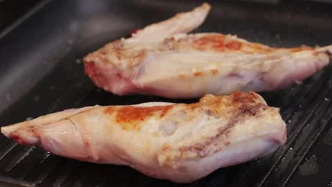 Roasted rabbit legs in a grill pan, healthy diet meat close up, chef cooking Stock Footage 267021587