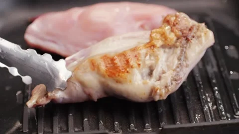 Roasted rabbit legs in a grill pan, healthy diet meat close up, chef cooking Stock Footage 267021617