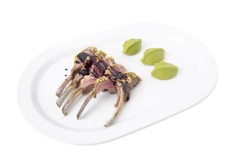 Roasted rack of lamb with pistachios. Stock Photos