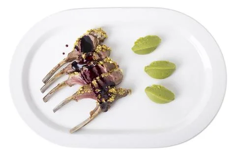 Roasted rack of lamb with pistachios. Stock Photos