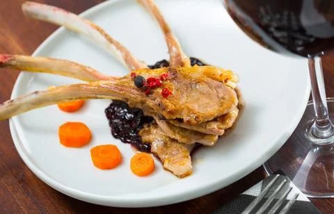 Roasted rack of mutton with berry sauce and carrot Stock Photos