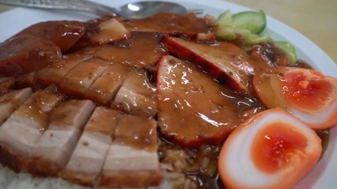 Roasted Red Pork, Crispy Pork, and Boiled Egg on Rice Video stock 296313905