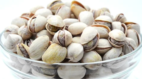 Roasted salted appetizing pistachios in glass bowl rotating Stock Footage 44907538