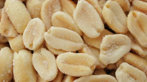 Roasted salted peanuts closeup macro revolving on a turntable Stock Footage 106378860