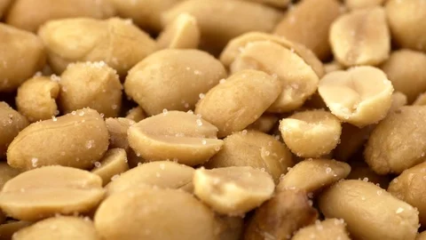 Roasted salted peanuts low angle shallow depth of field with rotation Stock Footage 86676394