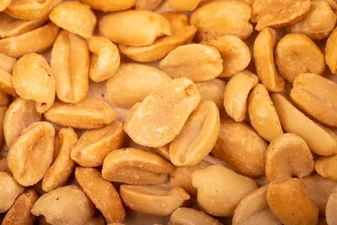 Roasted salted peanuts, surface texture. Close-up, selective focus. Stock Photos