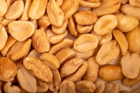 Roasted salted peanuts, surface texture. Close-up, selective focus. Stock Photos