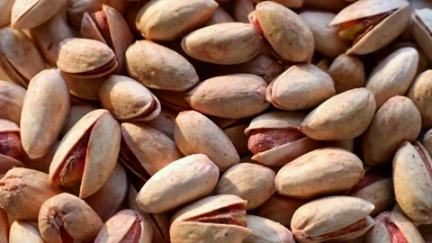 Roasted salted pistachio nuts in nutshell circle rotation close up top view Stock Footage 257122724
