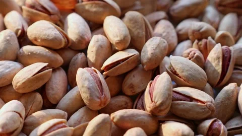Roasted salted pistachio nuts in nutshell falling down close up Stock Footage 257123070