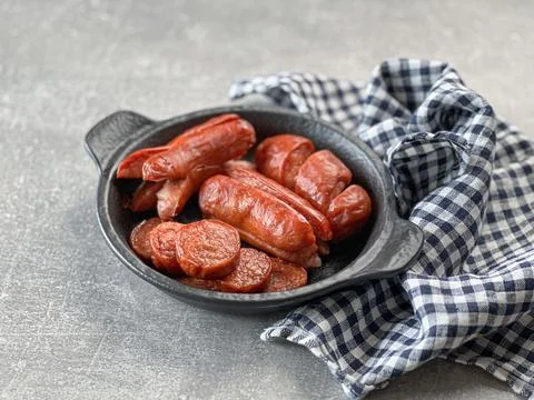 Roasted sausage. Different ways of preparing and slicing sausages on stick. 写真素材