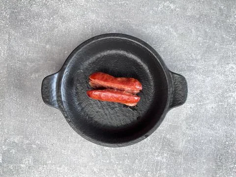 Roasted sausage sliced lengthwise. Preparing sausages for roasting on stick. Stock Photos