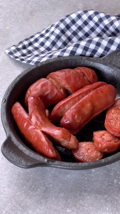 Roasted sausages. Different ways of slicing sausages on stick. Overhead shot. Stock Footage 264778018