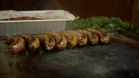 Roasted sausages on a hot griddle Stock Footage 263365089