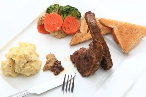 Roasted sheep meat with bones on dish Stock Photos