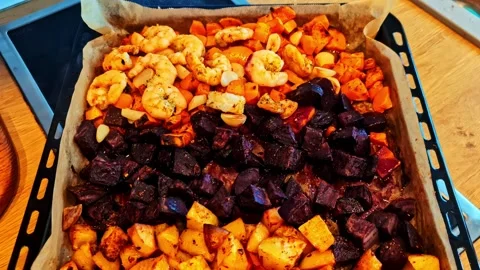 Roasted shrimp and root vegetables on tray Stock Footage 323246305