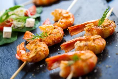 Roasted shrimp starter on skewer. Stock Photos