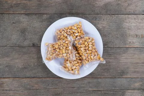 Roasted soybeans In Transparent Small Plastic Packaging on a white plate. O.. Stock Photos