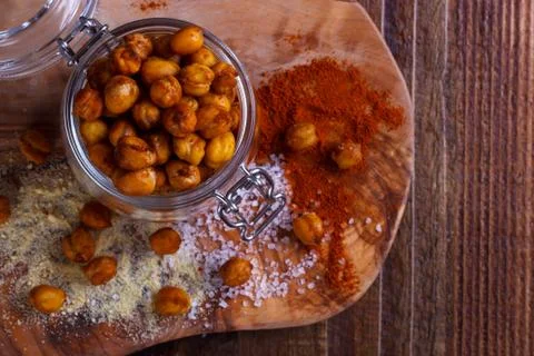 Roasted spicy chickpeas on rustic background Stock Photos