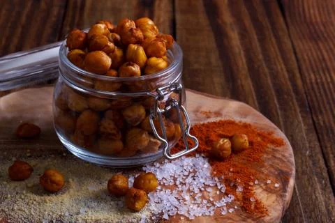 Roasted spicy chickpeas on rustic background Stock Photos