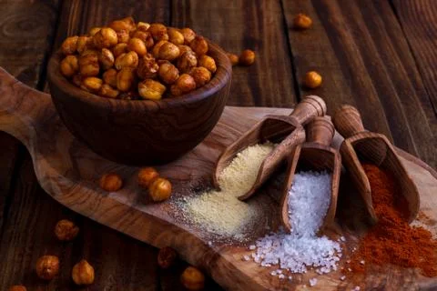 Roasted spicy chickpeas on rustic background Stock Photos