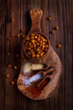 Roasted spicy chickpeas on rustic background Stock Photos