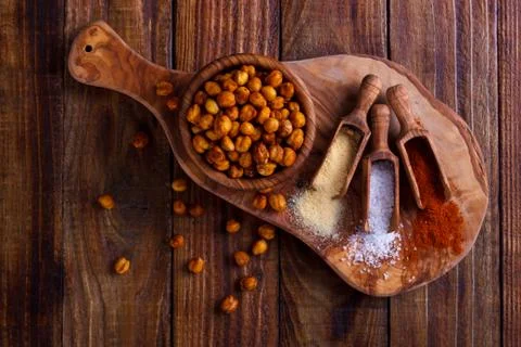 Roasted spicy chickpeas on rustic background Stock Photos