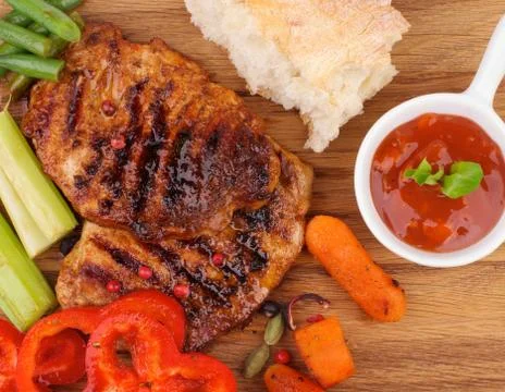 Roasted steaks and vegetables Stock Photos
