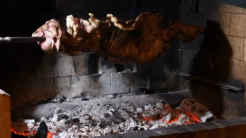 Roasted to the sword of half a lamb spinning over the burning coals. This way Stock Footage 126078034