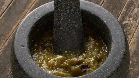 Roasted tomatillo salsa in molcajete. Stock Footage 313634103