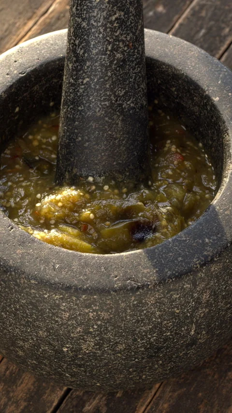 Roasted tomatillo salsa in molcajete. Vertical video. Stock Footage 313634085