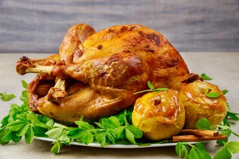Roasted turkey garnished with caramel apples and clover leaves. Stock Photos