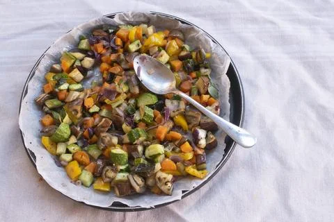 Roasted vegetable medley with spoon Stockfoto's