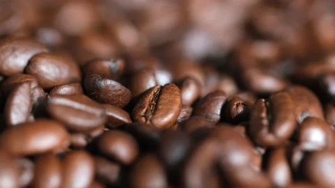 Roasted vietnamese coffee bean. Fragrant coffee beans scrolls slowly around the Stock Footage 151152264
