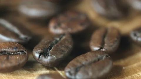 Roasted vietnamese coffee bean. Fragrant coffee beans scrolls slowly around the  Stock Footage 153779735