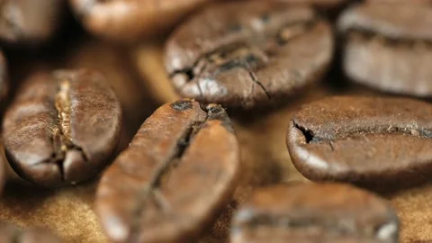 Roasted vietnamese coffee bean. Fragrant coffee beans scrolls slowly around the Stock Footage 153823805