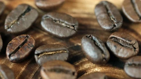 Roasted vietnamese coffee bean. Fragrant coffee beans scrolls slowly around the  Stock Footage 154146588