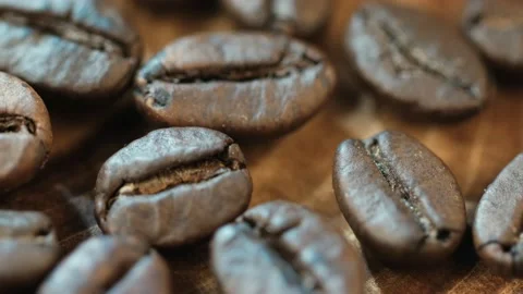Roasted vietnamese coffee bean. Fragrant coffee beans scrolls slowly around the  Stock Footage 154146924