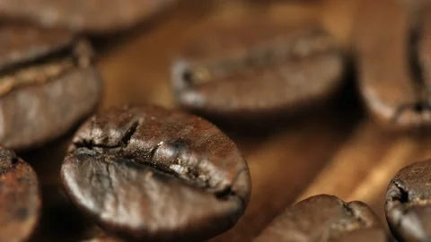 Roasted vietnamese coffee bean. Fragrant coffee beans scrolls slowly around the  Stock Footage 154147130