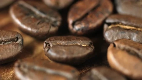 Roasted vietnamese coffee bean. Fragrant coffee beans scrolls slowly around the  Video stock 154147195