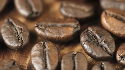Roasted vietnamese coffee bean. Fragrant coffee beans scrolls slowly around the  Stock Footage 154152311