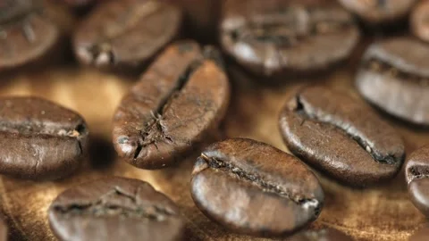 Roasted vietnamese coffee bean. Fragrant coffee beans scrolls slowly around the  Stock Footage 154152748