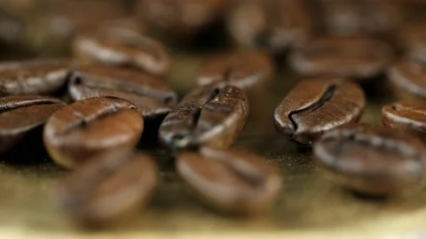 Roasted vietnamese coffee bean. Fragrant coffee beans scrolls slowly around the  Stock Footage 154153442