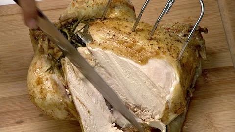 Roasted whole chicken with thyme. Slices being carved from breast Video stock 102137595